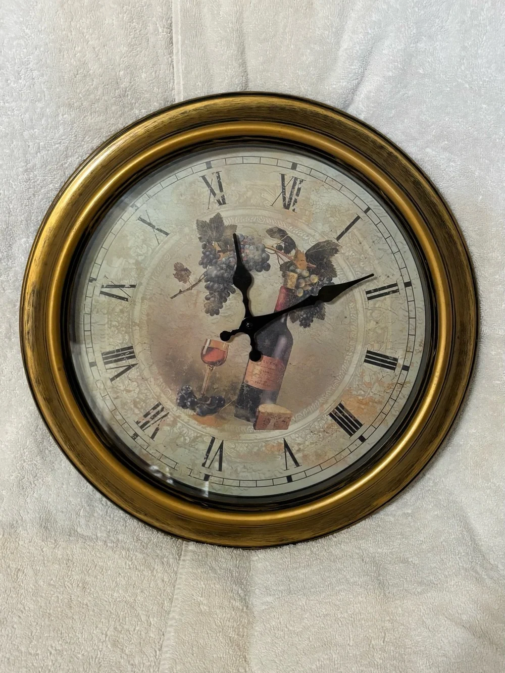 Gold-Finish Round Wall Clock with Roman Numerals and Vintage Illustration